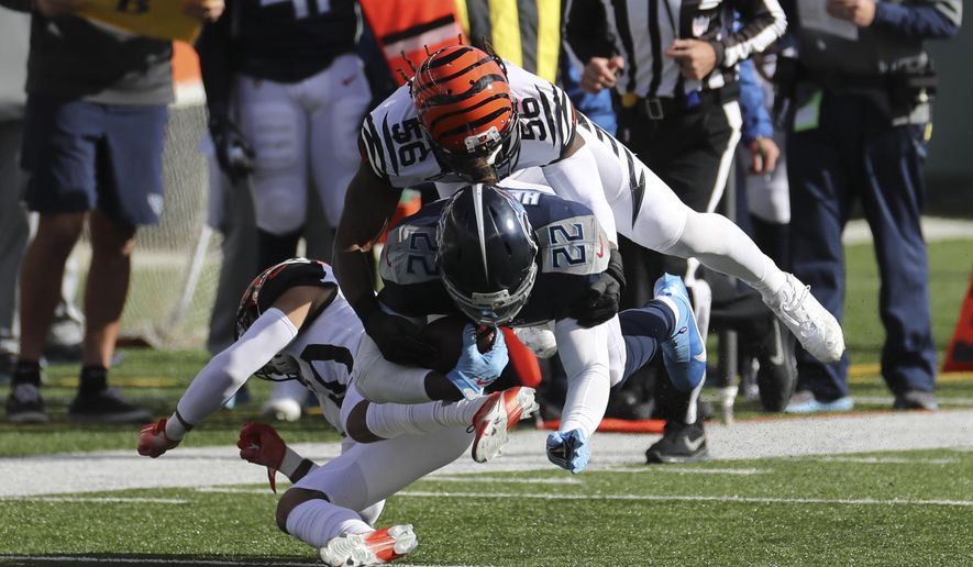 Tennessee Titans' Derrick Henry (22) is tackled by Cincinnati Bengals' Josh Bynes (56) during the first half of an NFL football game, Sunday, Nov. 1, 2020, in Cincinnati. (AP Photo/Jay LaPrete)