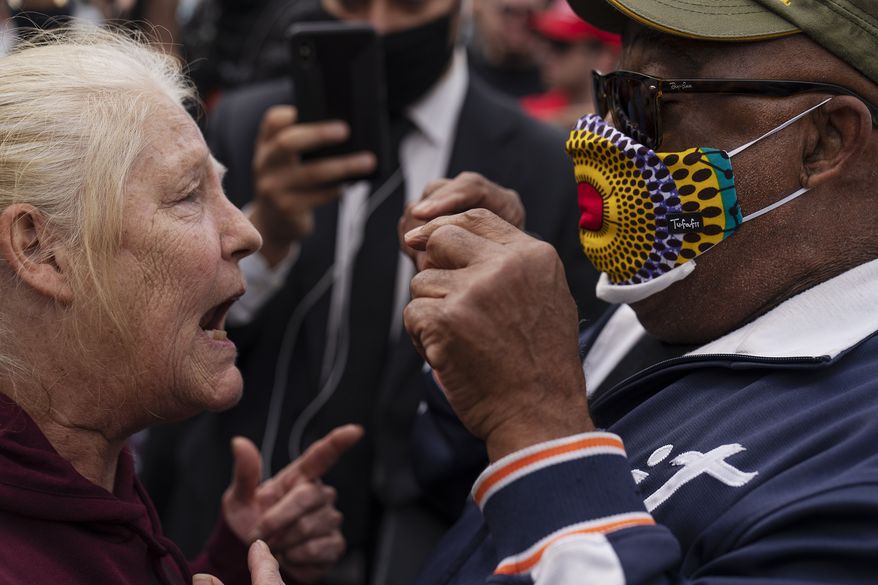 A Trump supporter at left argues with a counter protestor as Trump supporters demonstrate against the election results outside the central counting board at the TCF Center in Detroit, Mich., Thursday, Nov. 5, 2020. (AP Photo/David Goldman)