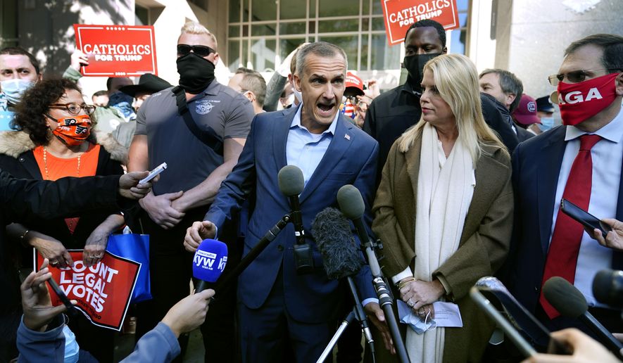 President Donald Trump&#39;s campaign advisor Corey Lewandowski, center, speaks about a court order obtained to grant more access to vote counting operations at the Pennsylvania Convention Center, Thursday, Nov. 5, 2020, in Philadelphia, following Tuesday&#39;s election. At right is former Florida Attorney General Pam Bondi. (AP Photo/Matt Slocum)