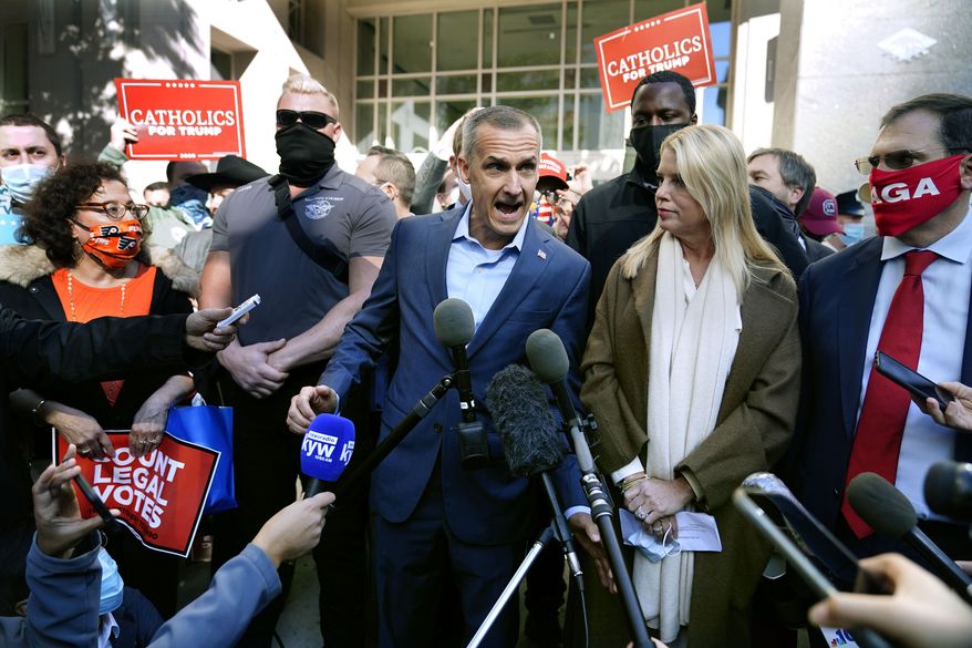 President Donald Trump&#39;s campaign advisor Corey Lewandowski, center, speaks about a court order obtained to grant more access to vote counting operations at the Pennsylvania Convention Center, Thursday, Nov. 5, 2020, in Philadelphia, following Tuesday&#39;s election. At right is former Florida Attorney General Pam Bondi. (AP Photo/Matt Slocum)