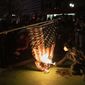 Protesters burn a national flag during a march following the presidential election Wednesday, Nov. 4, 2020, in Portland, Ore. (AP Photo/Paula Bronstein)