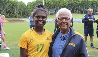 In this photo released by the Moriarty Foundation, Shadeene Evans, left, stands with John Moriarty at her debut for Australia’s Young Matilda’s under-20 national women’s soccer team on March 16, 2018, in Sydney, Australia. With the support of the Moriarty Foundation, Evans went from playing for fun with her mates in the tropics of the Top End to studying at an elite sports high school in urban Sydney, catching the attention of the national women&#39;s coach, and making her way into Australia’s top-flight women’s league with Sydney FC. (Moriarty Foundation via AP)