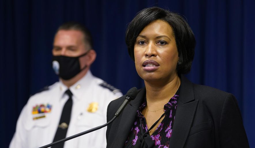 District of Columbia Mayor Muriel Bowser, right, standing next to Metropolitan Police Department chief Peter Newsham, left, speaks during a news conference in Washington, Wednesday, Nov. 4, 2020. (AP Photo/Susan Walsh)