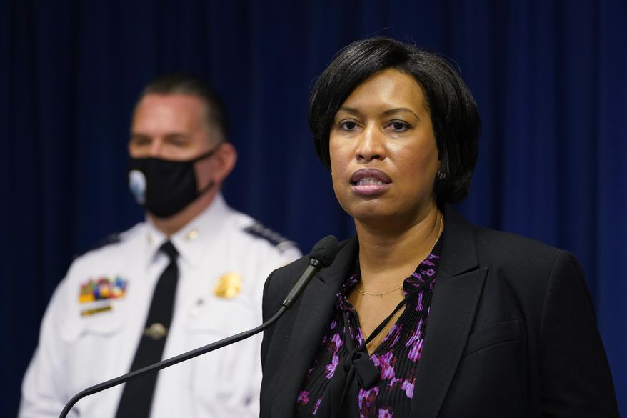 District of Columbia Mayor Muriel Bowser, right, standing next to Metropolitan Police Department chief Peter Newsham, left, speaks during a news conference in Washington, Wednesday, Nov. 4, 2020. (AP Photo/Susan Walsh)