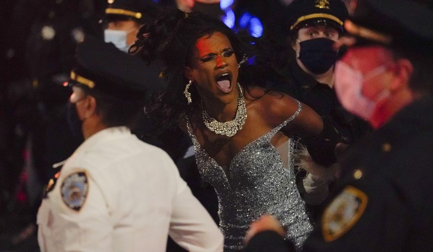 New York Police officers arrest a drag queen during a weekly "We Choose Freedom" march through the West Village, Thursday, Nov. 5, 2020, in New York. (AP Photo/Seth Wenig)