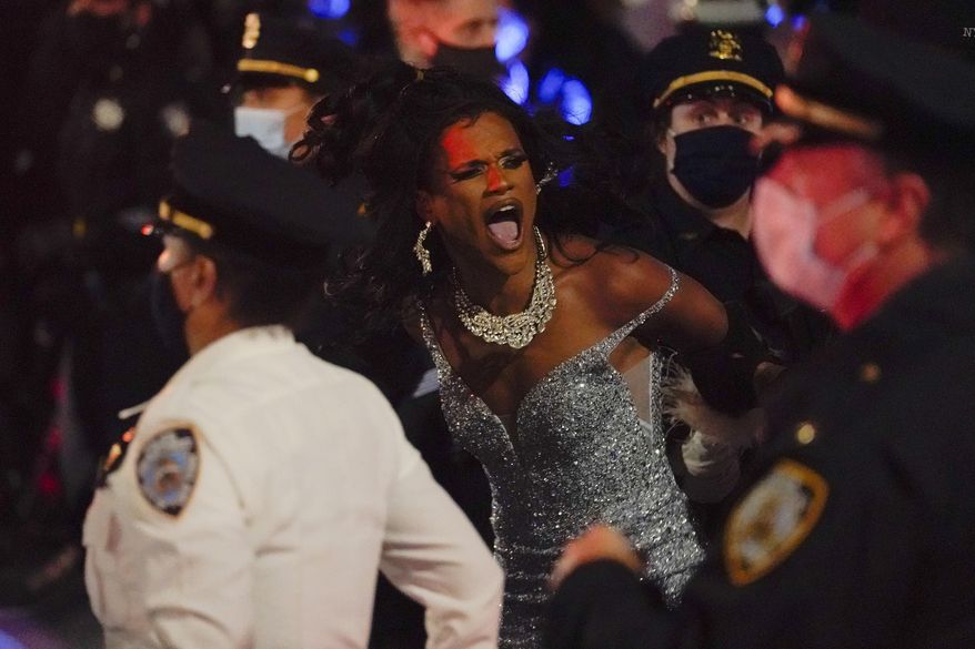 New York Police officers arrest a drag queen during a weekly "We Choose Freedom" march through the West Village, Thursday, Nov. 5, 2020, in New York. (AP Photo/Seth Wenig)