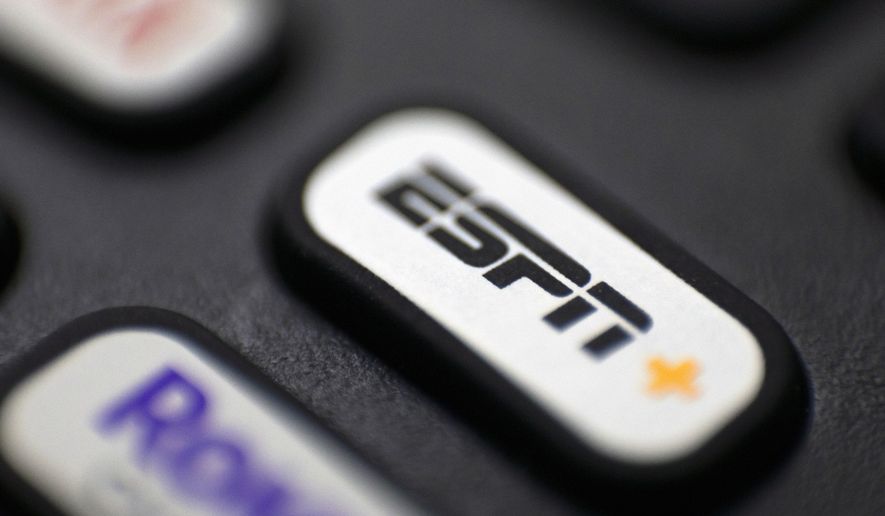 This Aug. 13, 2020 file photo shows a logo for ESPN on a remote control, in Portland, Ore. (AP Photo/Jenny Kane, File)