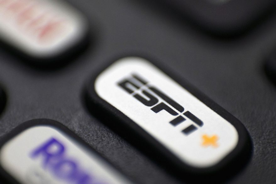 This Aug. 13, 2020 file photo shows a logo for ESPN on a remote control, in Portland, Ore. (AP Photo/Jenny Kane, File)