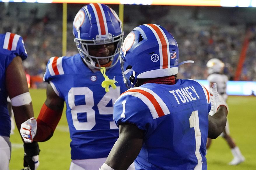Florida tight end Kyle Pitts (84) celebrates with wide receiver Kadarius Toney (1) after Toney ran a 16-yard touchdown against Missouri during the second half of an NCAA college football game, Saturday, Oct. 31, 2020, in Gainesville, Fla. (AP Photo/John Raoux)