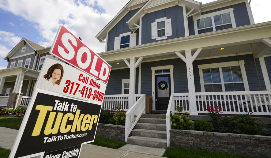 FILE - A &amp;quot;sold&amp;quot; sign is posted on a home in Westfield, Ind., Friday, Sept. 25, 2020.  On Thursday, Nov. 5, U.S. long-term mortgage rates were flat to lower this week, as the key 30-year rate fell to a new all-time low for the 12th time this year.   (AP Photo/Michael Conroy)