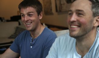 Brothers, Bryan, left, and Bradford Manning, laugh as they tell the origin story of their clothing company, Two Blind Brothers, in their New York City loft on Friday, Oct. 23, 2020. The brothers who&#39;ve lost much of their vision to a rare degenerative eye disorder began their company in 2016 and have donated all of their profits, more than $700,000, to preclinical research trials to help cure blindness. (AP Photo/Jessie Wardarski)