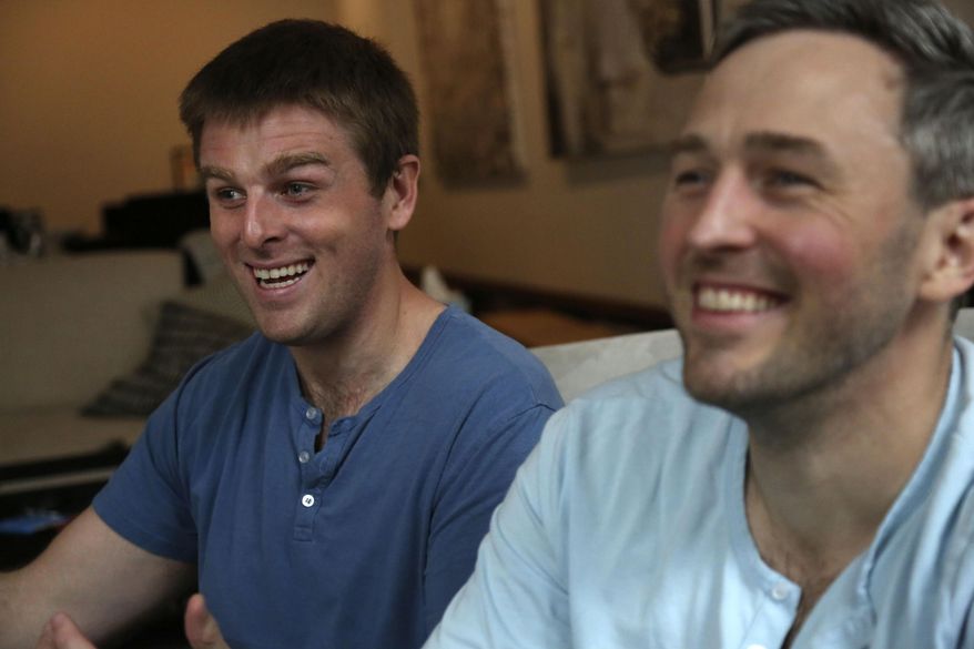Brothers, Bryan, left, and Bradford Manning, laugh as they tell the origin story of their clothing company, Two Blind Brothers, in their New York City loft on Friday, Oct. 23, 2020. The brothers who&#39;ve lost much of their vision to a rare degenerative eye disorder began their company in 2016 and have donated all of their profits, more than $700,000, to preclinical research trials to help cure blindness. (AP Photo/Jessie Wardarski)