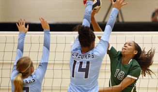 Reagan’s Kyla Waiters, right, spikes the ball past Johnson from the Texas District 26-6A high school volleyball match Friday, Sept. 22, 2017. Waiters, who went on to sign a scholarship at Oregon State, was among a half-dozen players who reached out to The Associated Press after a July 2020 story in which players, parents and people familiar with the program said Oregon State coaches physically and emotionally abused some players while the administration took no outward steps to address complaints. (Ron Cortes/The San Antonio Express-News via AP)