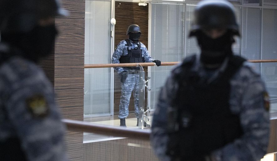 Security officers standing guard at the Alexei Navalny&#39;s Foundation for Fighting Corruption office in Moscow, Russia, Thursday, Nov. 5, 2020. Authorities in Moscow on Thursday raided the offices of opposition leader Alexei Navalny&#39;s organization, Putin’s most visible and determined opponent, the searches he described as part of Kremlin efforts to stop his activities. (AP Photo/Pavel Golovkin)