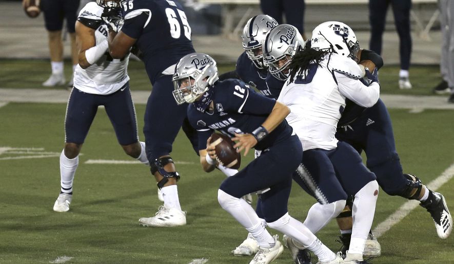 Nevada quarterback Carson Strong (12) during the first half of the team's NCAA college football game against Utah State on Thursday, Nov. 5, 2020, in Reno, Nev. (AP Photo/Lance Iversen)