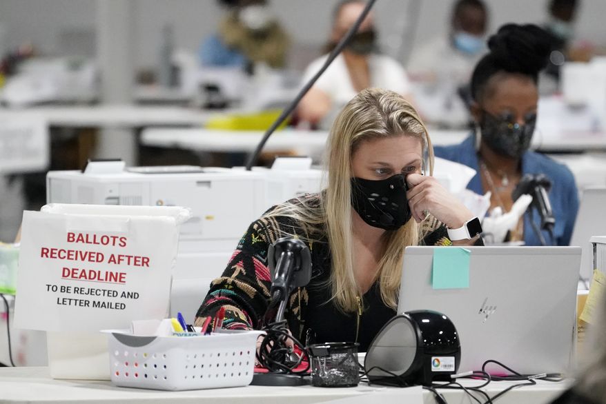 Workers at the Gwinnett County Voter Registration and Elections Headquarters, Friday, Nov. 6, 2020, in Lawrenceville, near Atlanta. (AP Photo/John Bazemore)  **FILE**