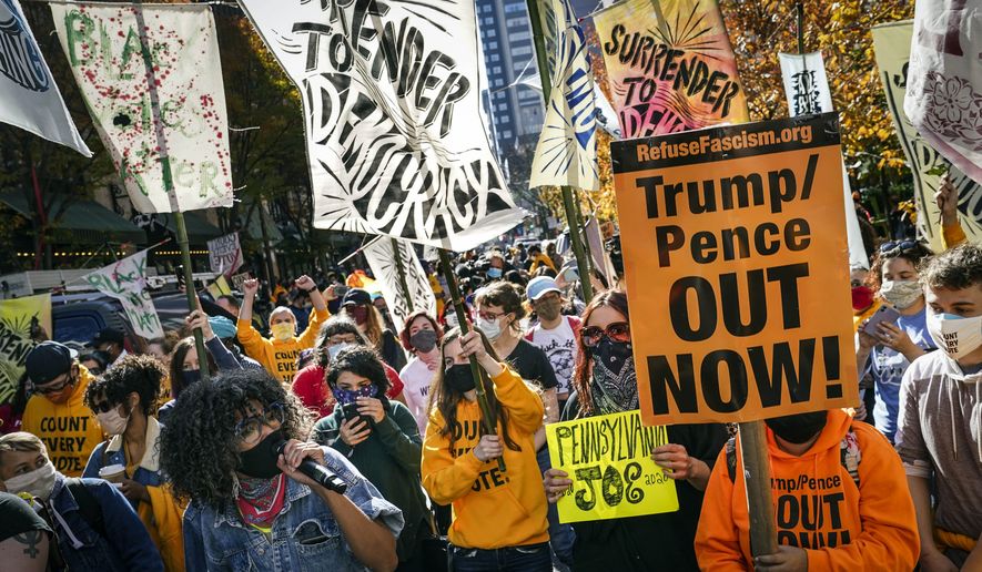 People urge for all votes to be counted as they demonstrate outside the Pennsylvania Convention Center where votes are being counted, Friday, Nov. 6, 2020, in Philadelphia. (AP Photo/John Minchillo)
