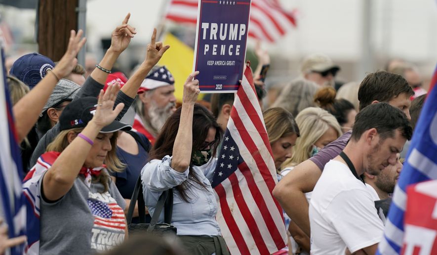 Supporters of President Donald Trump pray at a rally outside the Maricopa County Recorder&#x27;s Office Friday, Nov. 6, 2020, in Phoenix. (AP Photo/Ross D. Franklin)