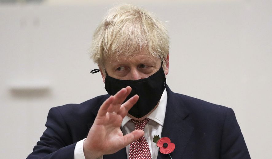 Britain&#39;s Prime Minister Boris Johnson gestures during a visit to a coronavirus testing center in De Montfort University, Leicester, England, in this file photo from Friday Nov. 6, 2020.  Mr. Johnson on Nov. 7 sent along his congratulations to President-elect Joseph R. Biden upon news that major news organizations had called the election in his favor. (Molly Darlington/Pool via AP)  **FILE**