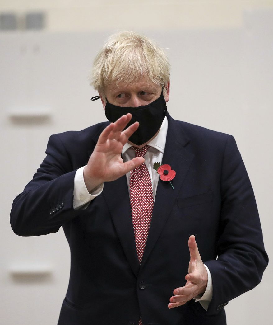 Britain's Prime Minister Boris Johnson gestures during a visit to a coronavirus testing center in De Montfort University, Leicester, England, in this file photo from Friday Nov. 6, 2020. Mr. Johnson on Nov. 7 sent along his congratulations to President-elect Joseph R. Biden upon news that major news organizations had called the election in his favor. (Molly Darlington/Pool via AP) **FILE**