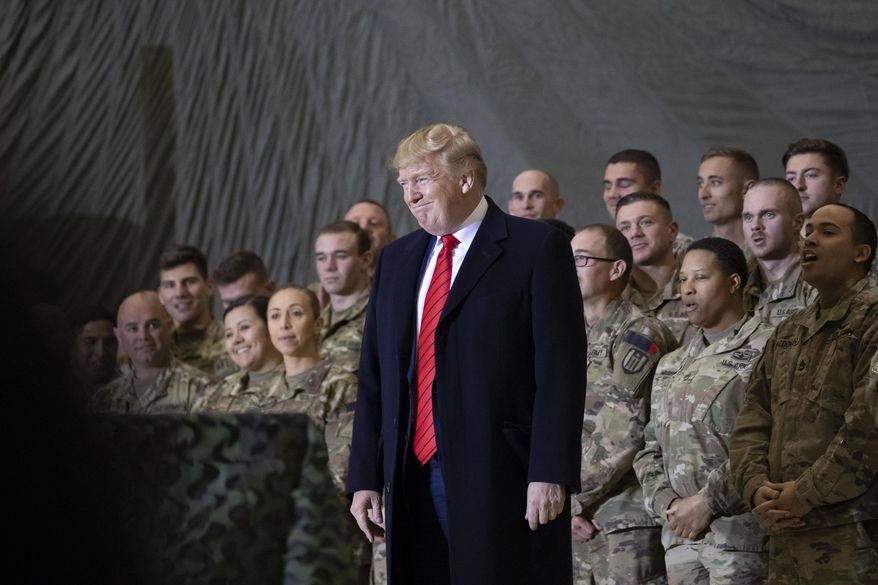 In this Nov. 28, 2019, photo, President Donald Trump smiles before addressing members of the military during a surprise Thanksgiving Day visit at Bagram Air Field, Afghanistan. (AP Photo/Alex Brandon) **FILE**