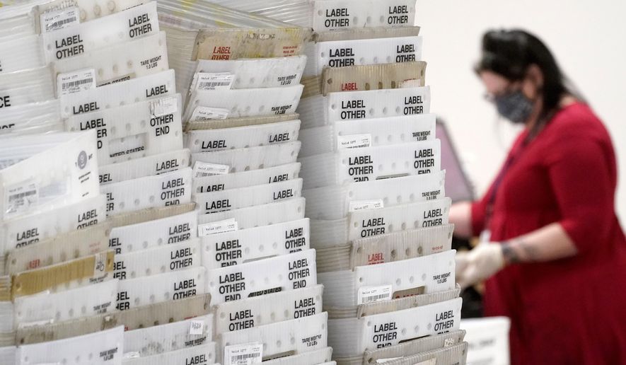 Stacks of ballots await to be counted for the general election inside the Maricopa County Recorder&#39;s Office, Friday, Nov. 6, 2020, in Phoenix. (AP Photo/Matt York)