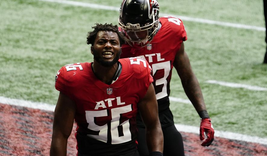 Atlanta Falcons defensive end Dante Fowler Jr. (56) celebrates a goal-line stop of the Detroit Lions during the first half of an NFL football game, Sunday, Oct. 25, 2020, in Atlanta. Fowler was called for unsportsmanlike conduct after a team mate knocked his helmet off during the celebration. (AP Photo/Brynn Anderson)
