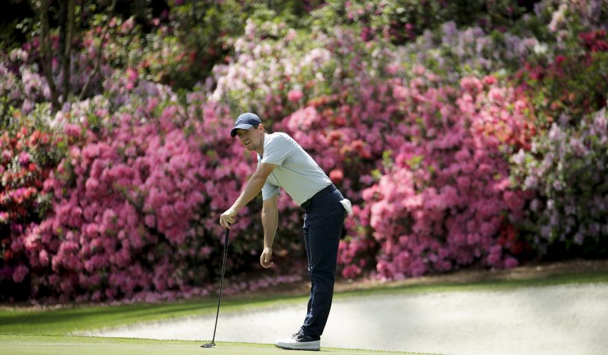 FILE - In this April 8, 2019, file photo, Rory McIlroy, of Northern Ireland, watches his putt on the 13th hole during a practice round for the Masters golf tournament in Augusta, Ga. Because of the coronavirus pandemic, the Masters is being held in November (Nov. 12-15) for the first time. (AP Photo/Charlie Riedel, File)