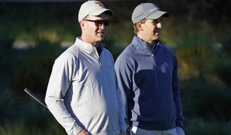 FILE - In this Feb. 6, 2020 file photo, Peyton Manning, left, and his brother Eli Manning wait to hit from the first tee of the Spyglass Hill Golf Course during the first round of the AT&amp;amp;T Pebble Beach National Pro-Am golf tournament in Pebble Beach, Calif. Both Mannings have become deejays. The former quarterbacks, two-time Super Bowl-winning brothers and close mates with Kenny Chesney, kicked off the “Poets &amp;amp; Pirates DJ Sessions” this week on the singer’s SiriusXM channel, No Shoes Radio. In addition to spinning the songs, the Mannings told stories about their personal meanings, as well as about their long-time friendships with Chesney. (AP Photo/Tony Avelar, File)