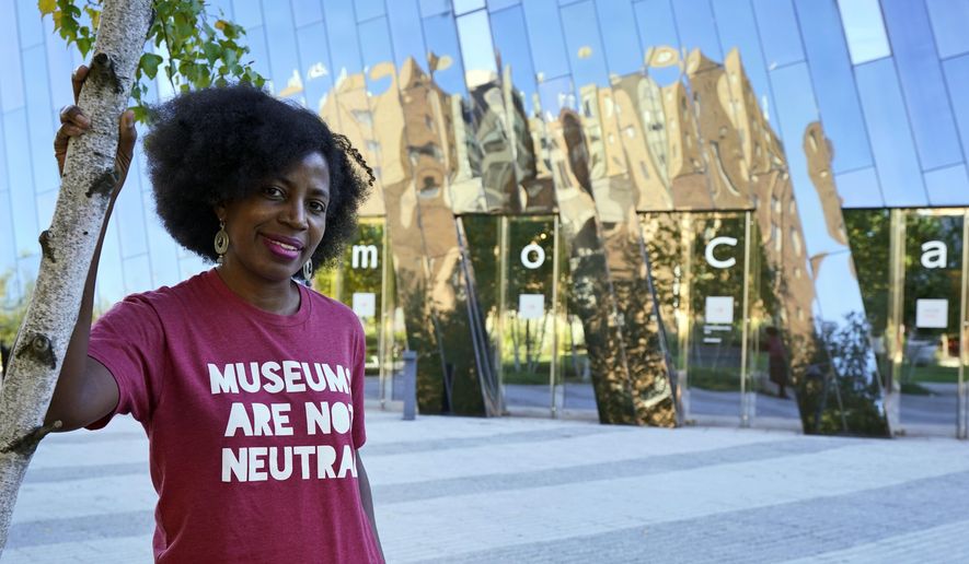 La Tanya Autry, a curatorial fellow at The Museum of Contemporary Art Cleveland, poses outside of the museum in Cleveland on Thursday, Oct. 8, 2020. Museums are being called on to examine what&#x27;s on their walls amid a national reckoning on racism. Among 18 major U.S. museums, 85% of artists featured are white, while 87% are men, according to a 2019 study conducted at Williams College. Autry helped start an initiative called Museums Are Not Neutral. (AP Photo/Tony Dejak)