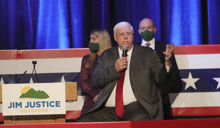 West Virginia Gov. Jim Justice celebrates his reelection at The Greenbrier Resort, Tuesday, Nov. 3, 2020, in White Sulphur Springs, W.Va.  Justice and his staff are being tested for the coronavirus after a staffer in the capitol building tested positive on Friday, Nov. 6. Justice says he was tested minutes before a noon press conference where he announced a record 540 new coronavirus cases in the past day. (AP Photo/Chris Jackson)