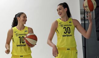 FILE - In this May 9, 2018, file photo, Seattle Storms players Sue Bird, left, and Breanna Stewart smile as pose a photo session during the WNBA basketball team&#39;s media day in Seattle. The Storm teammates are among a half-dozen WNBA players who have frozen their eggs according to the players union. (AP Photo/Elaine Thompson, File)