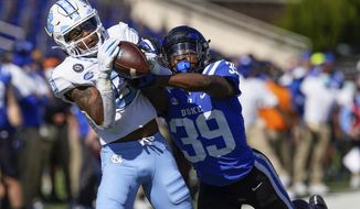 North Carolina wide receiver Emery Simmons (0) makes a touchdown catch as Duke cornerback Jeremiah Lewis (39) defends during the first half of an NCAA college football game at Wallace Wade Stadium, Saturday, Nov. 7, 2020, in Durham, N.C. (Jim Dedmon/Pool Photo via AP)