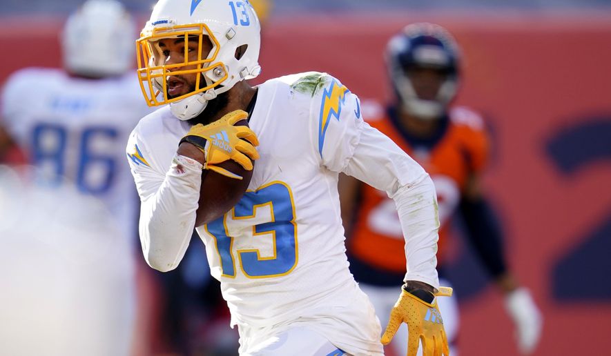 Los Angeles Chargers wide receiver Keenan Allen (13) scores a touchdown against the Denver Broncos during the first half of an NFL football game, Sunday, Nov. 1, 2020, in Denver. (AP Photo/David Zalubowski)