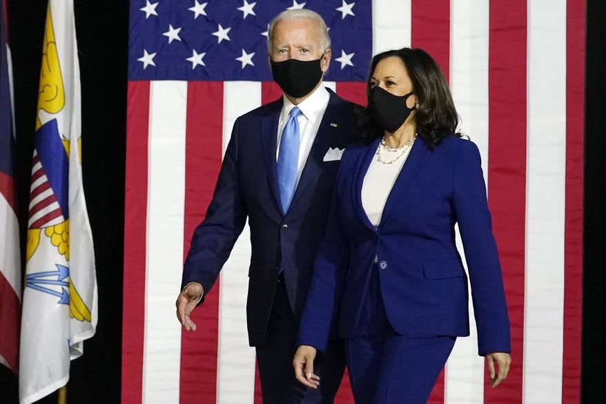 In this Aug. 12, 2020, file photo, Democratic presidential candidate former Vice President Joe Biden and his running mate Sen. Kamala Harris, D-Calif., arrive to speak at a news conference at Alexis Dupont High School in Wilmington, Del. (AP Photo/Carolyn Kaster, File)