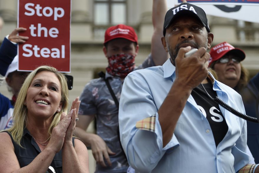 President Donald Trump supporters cheer as Georgia state Rep. Vernon Jones speaks, accompanied by Republican Congresswoman-elect Marjorie Taylor Greene, Saturday, Nov. 7, 2020, in Atlanta. (AP Photo/Mike Stewart) **FILE**