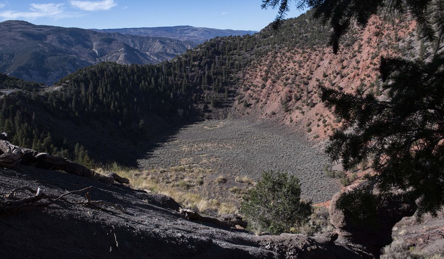 The Dotsero crater from its eruption 4,200 years ago is clear to see from above Tuesday, Oct. 13, 2020 near Glenwood Springs, Colo. The only active volcano in Colorado is just a rough 4-wheel drive road from Interstate 70 east of the Glenwood Canyon. (Christian Murdock/The Gazette via AP)