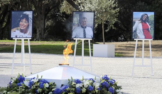 The portraits of, from the left, victims Nadine Devillers, Vincent Loques and Brazil&#39;s Simone Barreto Silva. Are pictured in Nice, southern France, Saturday Nov. 7, 2020, during a ceremony in homage to the three victims of an attack at Notre-Dame de Nice Basilica on October 29, 2020. Three people were killed in an Islamic extremist attack at Notre Dame Basilica in the city of Nice that pushed the country into high security alert. (Valery Hache; Pool via AP)