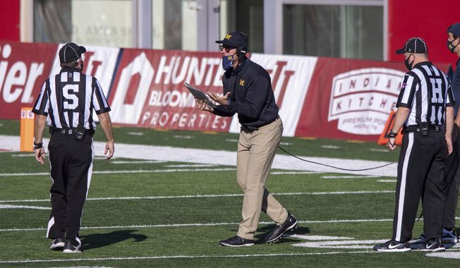 Michigan head coach Jim Harbaugh reacts towards a game official after a call during the second half of an NCAA college football game against Indiana, Saturday, Nov. 7, 2020, in Bloomington, Ind. Indiana won 38-21. (AP Photo/Doug McSchooler)