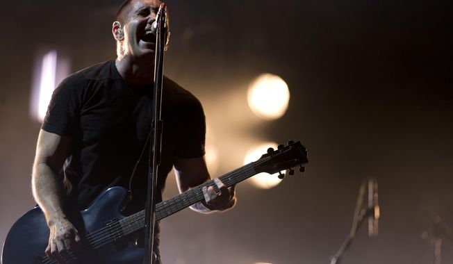 In this March 27, 2014 file photo, Trent Reznor of Nine Inch Nails performs at the Vive Latino music festival in Mexico City, Mexico. (AP Photo/Rebecca Blackwell, File)