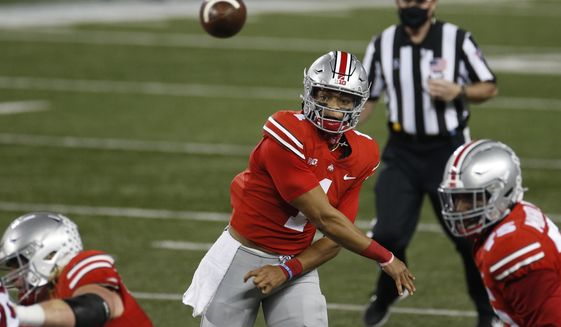 Ohio State quarterback Justin Fields throws a pass against Rutgers during the first half of an NCAA college football game Saturday, Nov. 7, 2020, in Columbus, Ohio. (AP Photo/Jay LaPrete)