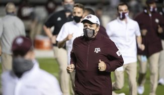 Texas A&amp;amp;M coach Jimbo Fisher runs off the field before the team&#39;s NCAA college football game against South Carolina on Saturday, Nov. 7, 2020, in Columbia, S.C. (AP Photo/Sean Rayford)