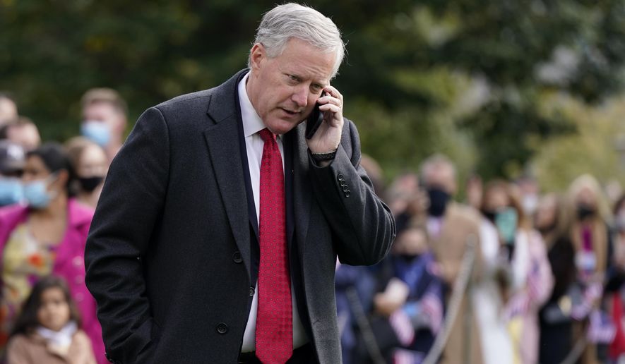 In this Oct. 30, 2020, photo, White House chief of staff Mark Meadows speaks on a phone on the South Lawn of the White House in Washington. Meadows has been diagnosed with the coronavirus as the nation sets daily records for confirmed cases for the pandemic. (AP Photo/Patrick Semansky)