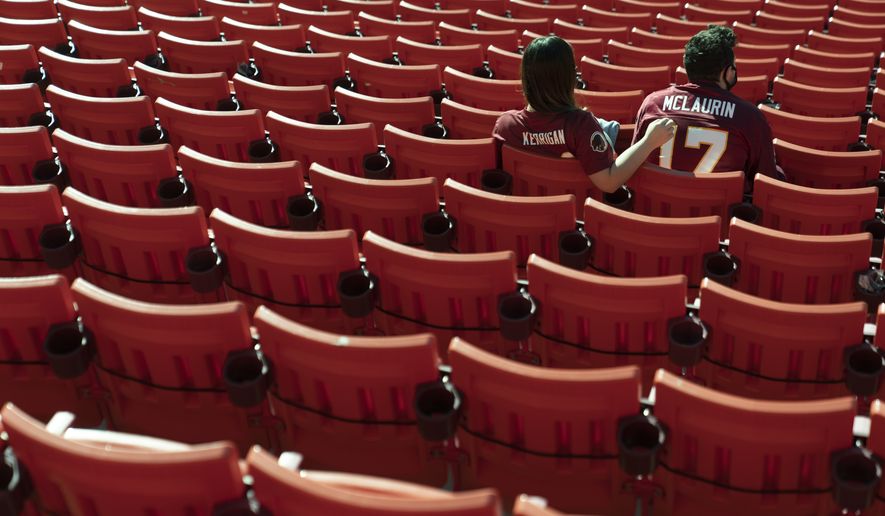 Fans take their seat at FedEx Field before the start of an NFL football game between the New York Giants and Washington Football Team, Sunday, Nov. 8, 2020, in Landover, Md. (AP Photo/Patrick Semansky)