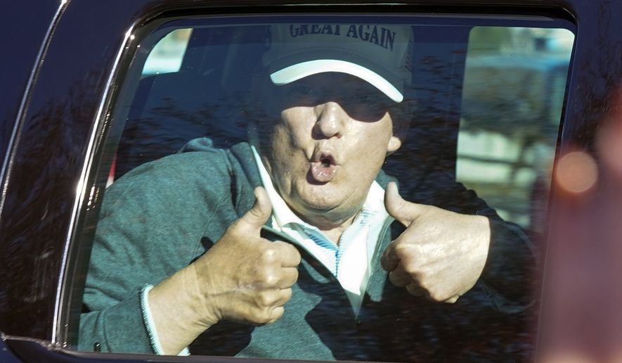President Donald Trump gives two thumbs up to supporters as he departs after playing golf at the Trump National Golf Club in Sterling Va., Sunday Nov. 8, 2020. (AP Photo/Steve Helber)