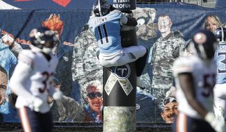 Tennessee Titans wide receiver A.J. Brown (11) jumps onto the goal post after catching a 40-yard touchdown pass against the Chicago Bears in the first half of an NFL football game Sunday, Nov. 8, 2020, in Nashville, Tenn. (AP Photo/Ben Margot)