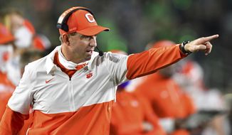Clemson coach Dabo Swinney signals to his players during the second quarter against Notre Dame in an NCAA college football game Saturday, Nov. 7, 2020, in South Bend, Ind. (Matt Cashore/Pool Photo via AP)