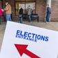 In this Oct. 29, 2020, file photo, voters line up as the doors open to the Election Center for absentee early voting for the general election in Sterling Heights, Mich. (AP Photo/David Goldman) ** FILE **