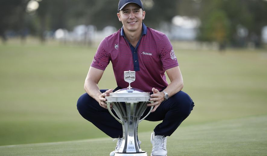 Carlos Ortiz poses with the champion's trophy after winning the Houston Open golf tournament, Sunday, Nov. 8, 2020, in Houston. (AP Photo/Eric Christian Smith)