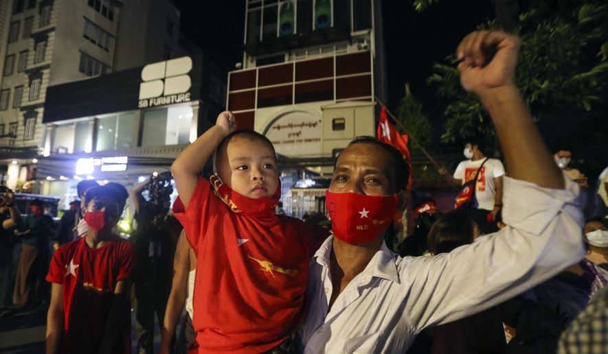 Supporters wearing face mask cheer as they gather in front of Myanmar Leader Aung San Suu Kyi&#39;s National League for Democracy (NLD) party&#39;s headquarters during Election Day Sunday, Nov. 8, 2020, in Yangon, Myanmar. (AP Photo/Thein Zaw)